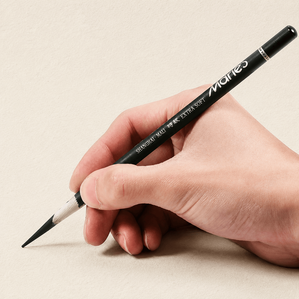 un crayon carbone extra soft, en main